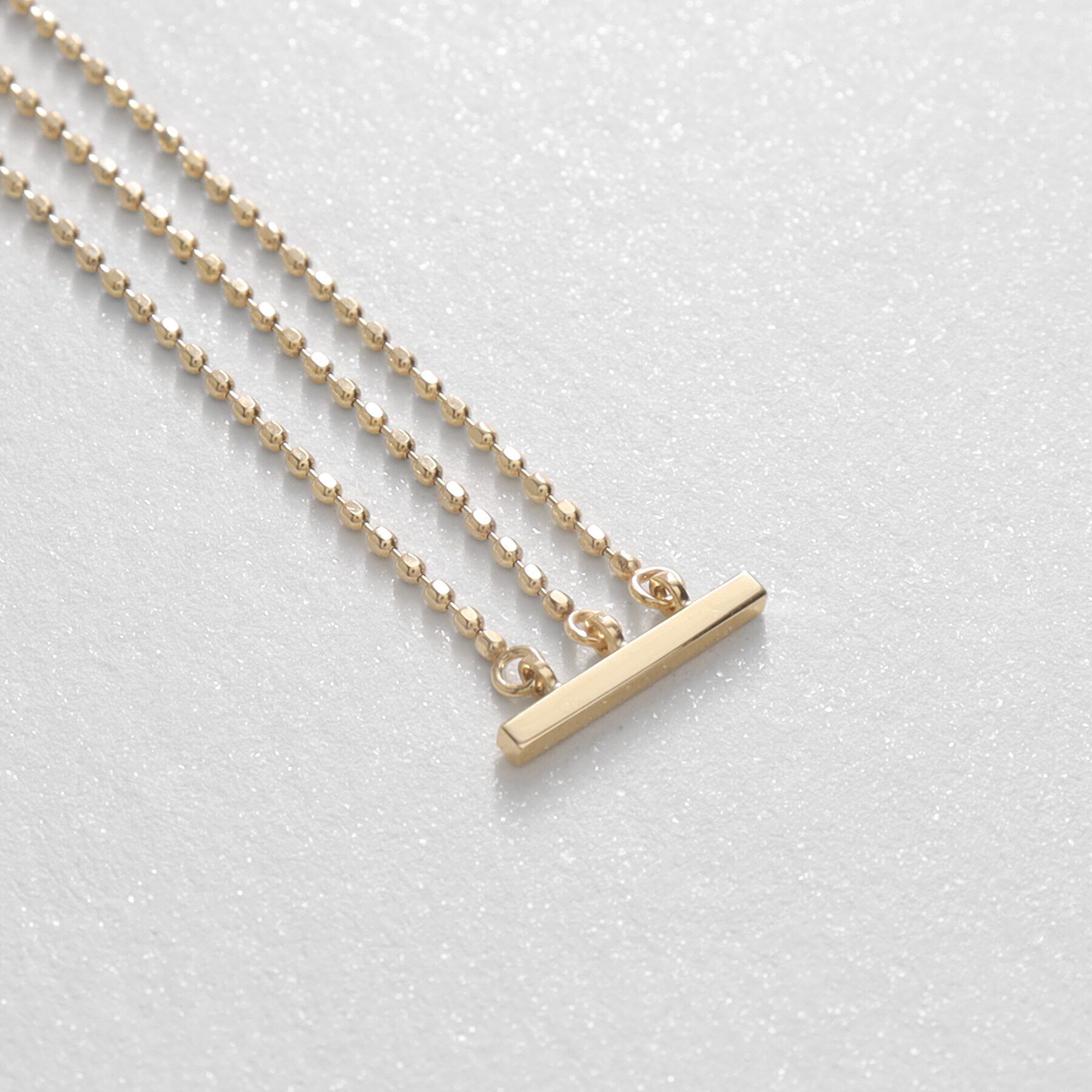 COCOSHNIK「K10カットボールチェーン3連 スタッドピアス」|ピアス|