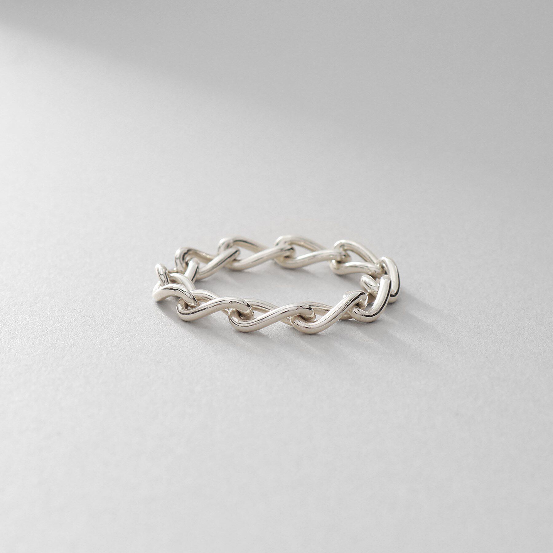 COCOSHNIK ONKITSCH「シルバー チェーンリング ロングカーブ」|リング|