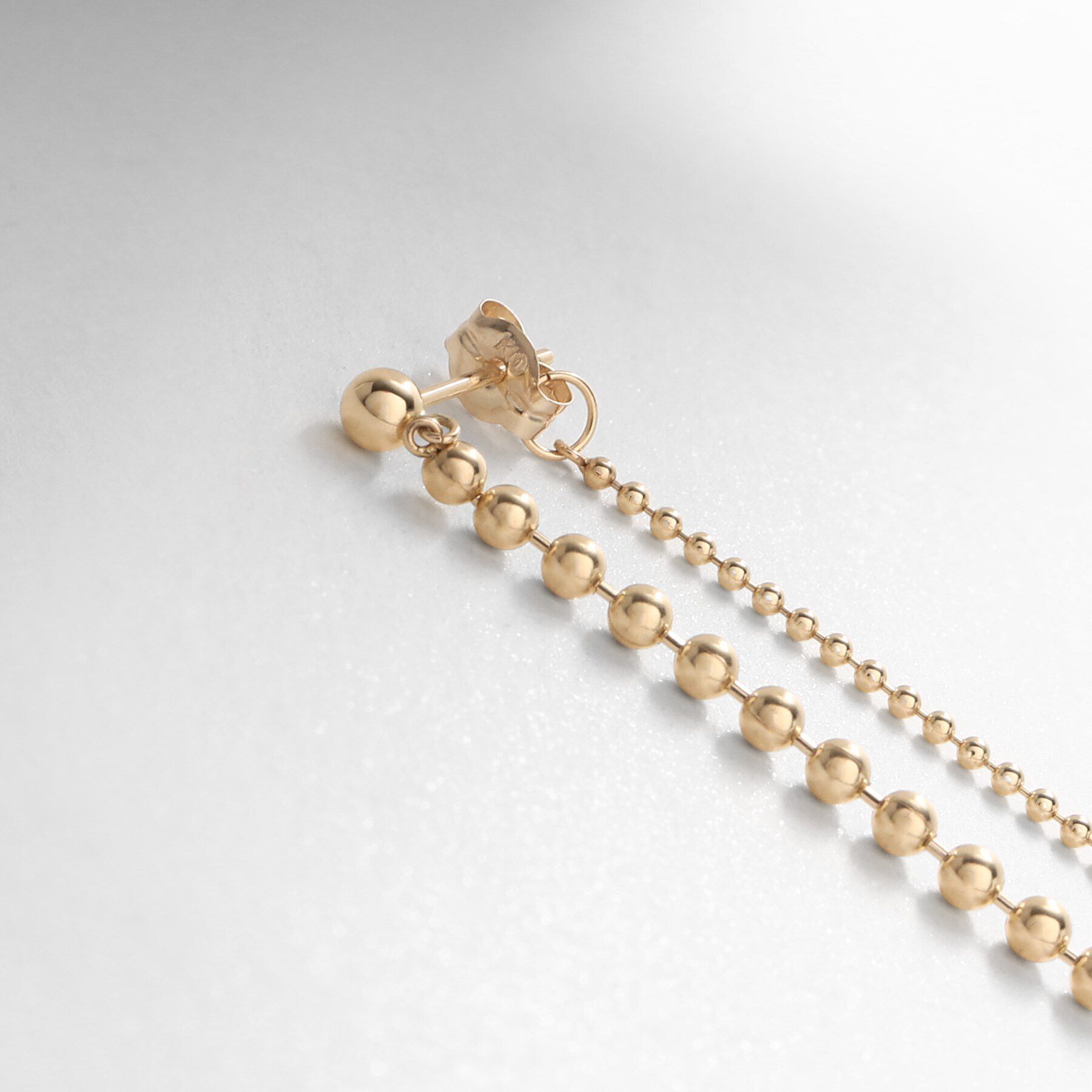 COCOSHNIK「K10ボールチェーン前後 スタッドピアス」|ピアス|