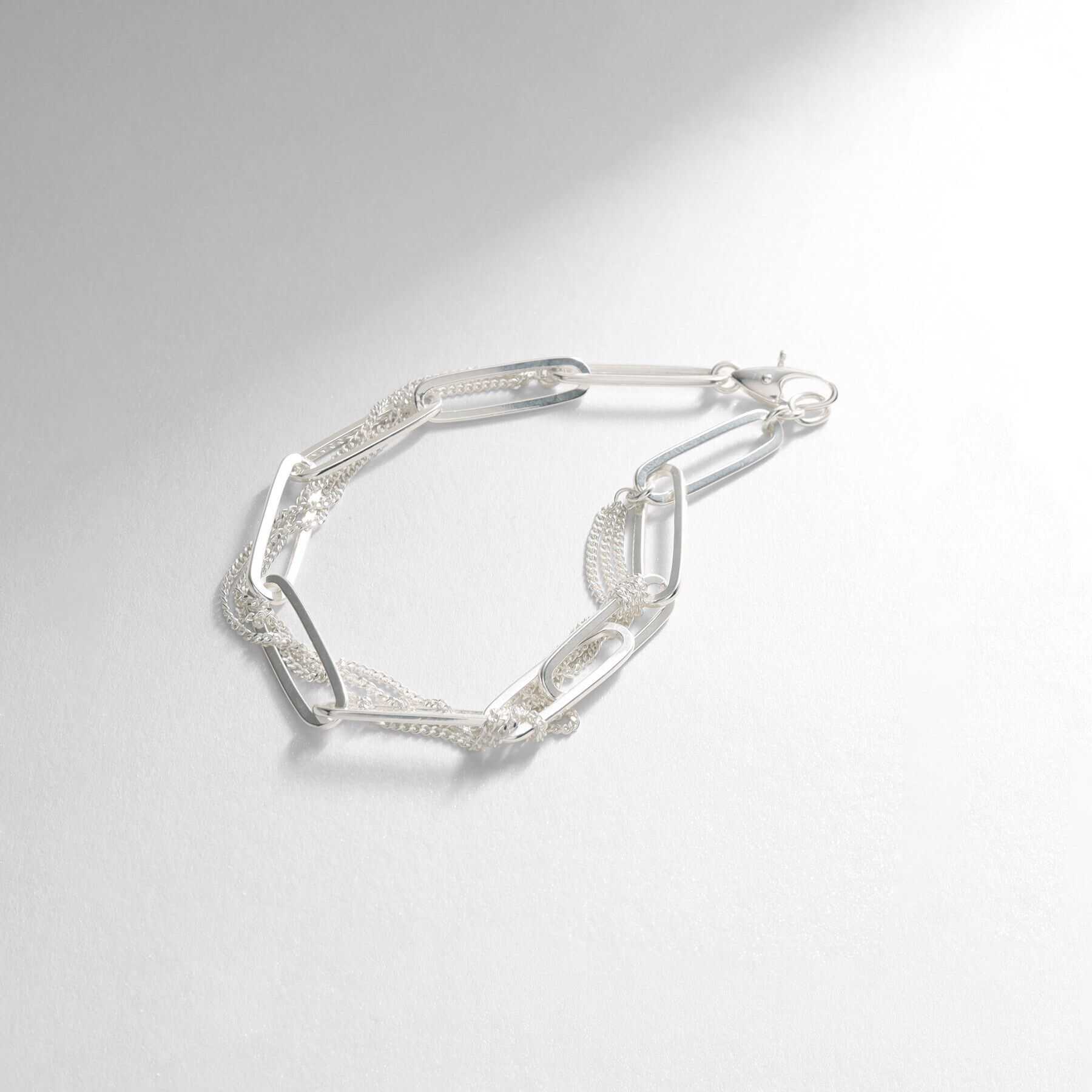 COCOSHNIK ONKITSCH「シルバー ミックスチェーン フラットカーブ スルー ブレスレット」|ブレスレット・バングル|