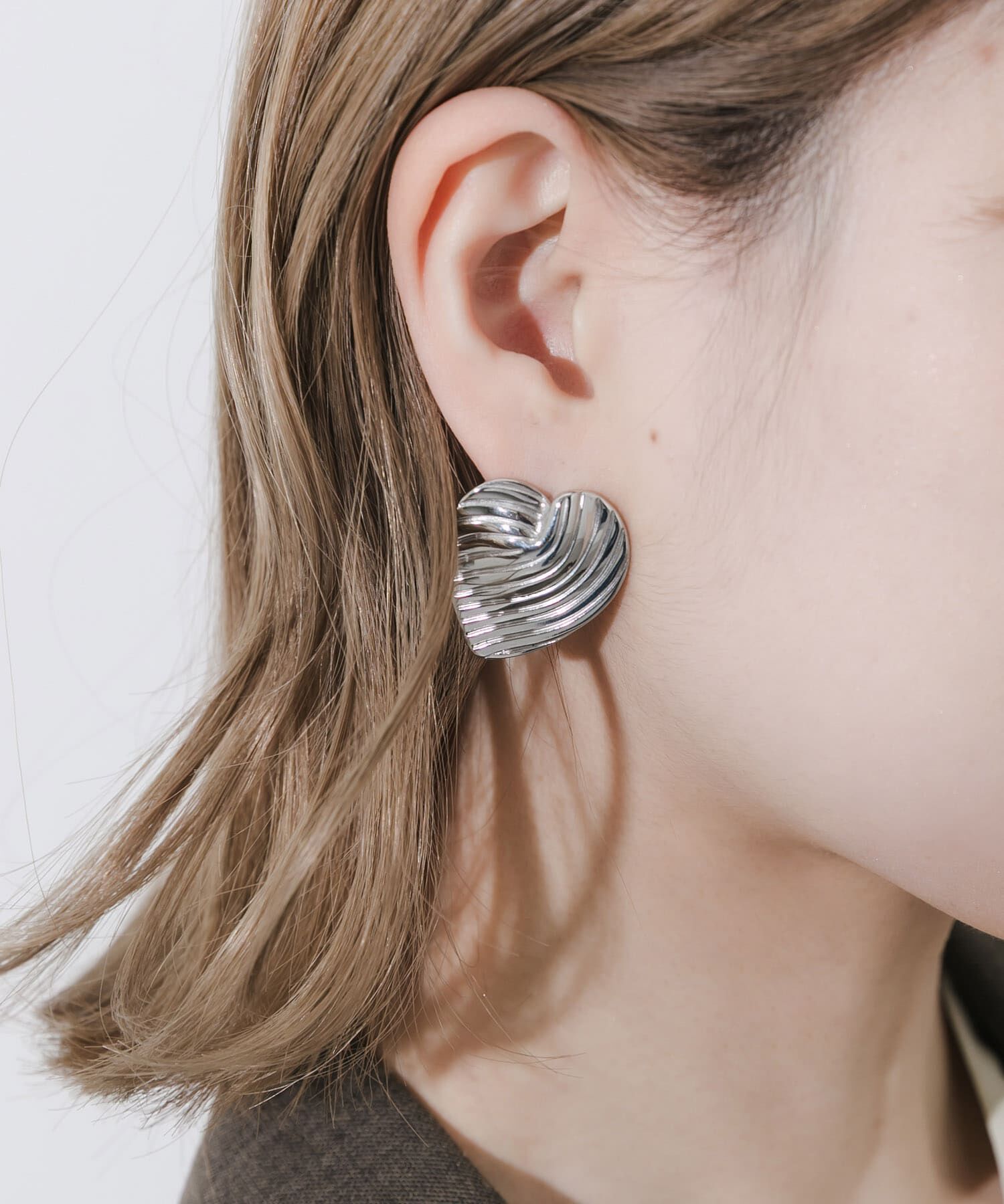 SMELLY「ステンレスウェーブラインハートピアス」|ピアス|