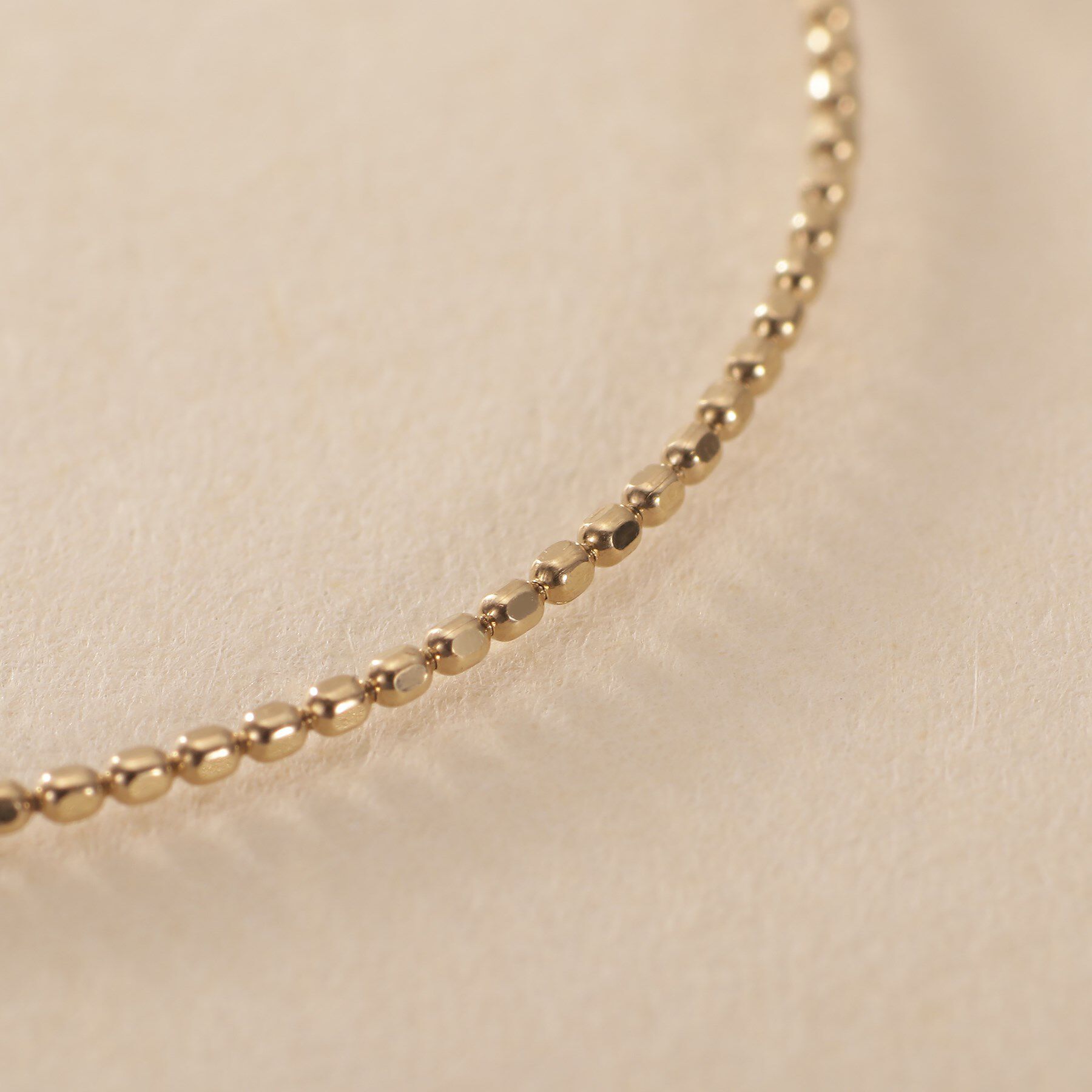 COCOSHNIK ONKITSCH「K10カットボールフープピアス」|ピアス|