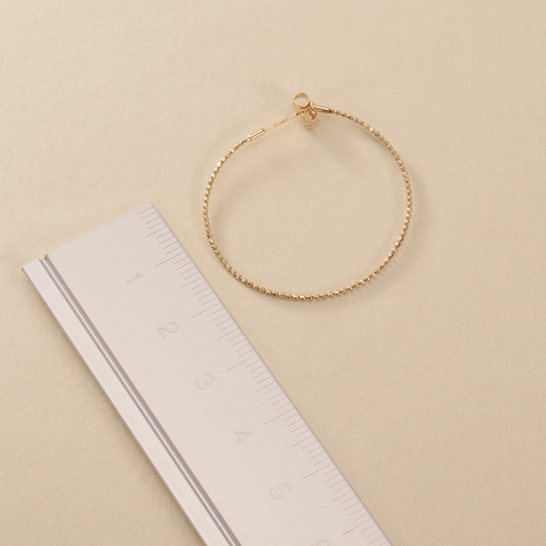 COCOSHNIK ONKITSCH「K10カットボールフープピアス」|ピアス|